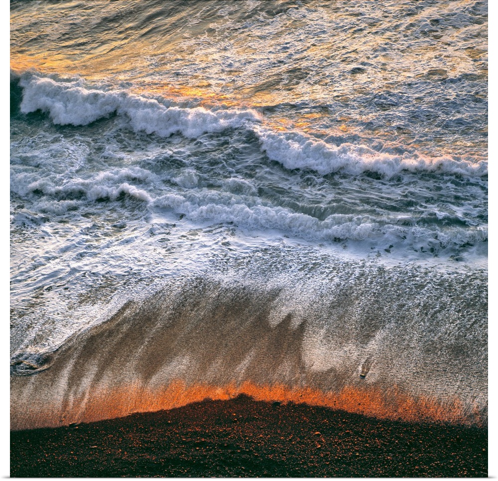 USA, California, Big Sur. Breaking surf catches the late fiery light of sunset at Big Sur on the California coast.