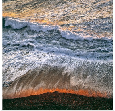 California, surf catches the light of sunset at Big Sur on the California coast