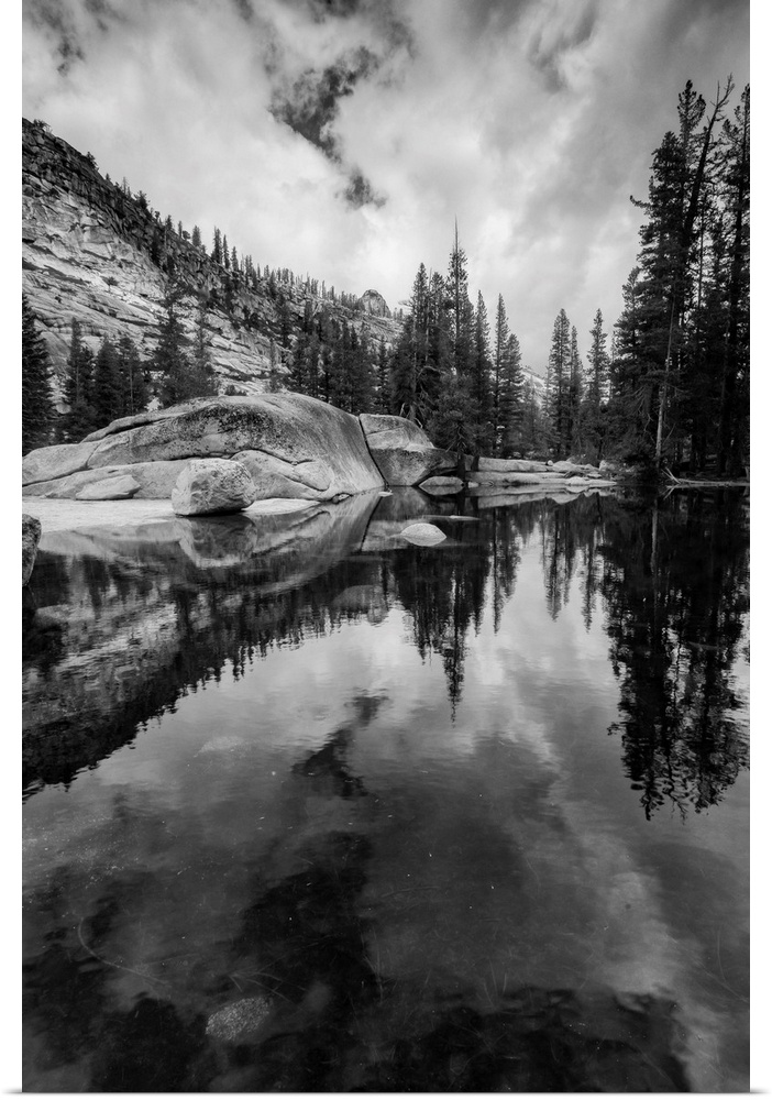 North America, USA, California, Yosemite National Park.  Black and White image of granite outcropping with boulders, cloud...