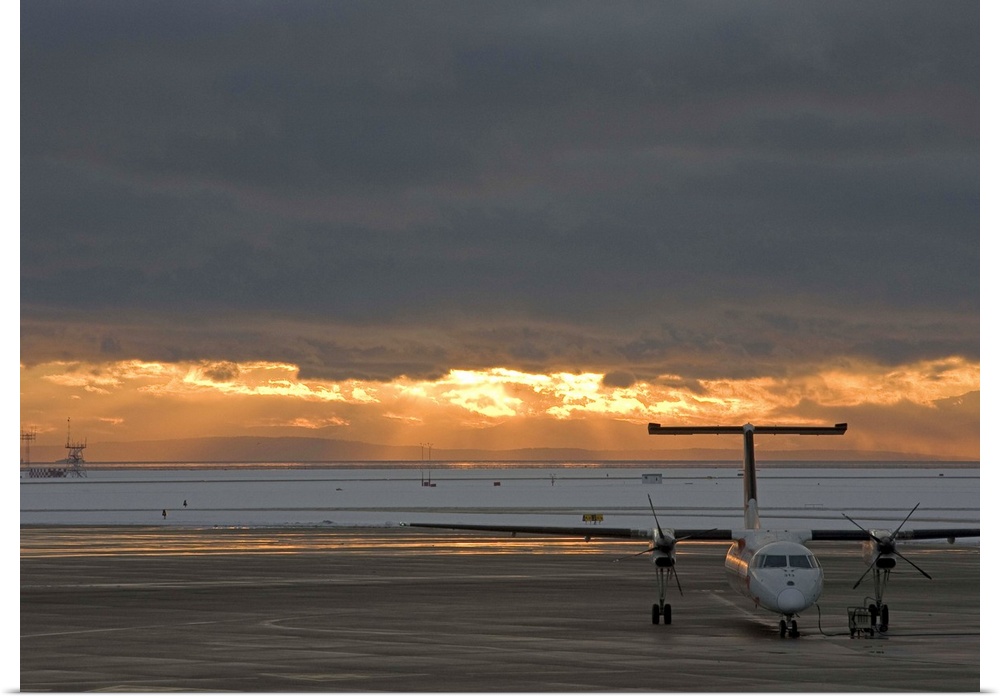 Canada, British Columbia, Vancouver. Dash 8 aircraft with sun lighting distant clouds. Credit as: Bill Young / Jaynes Gall...