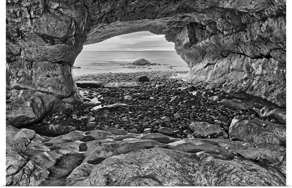 Canada, Newfoundland, the Arches Provincial park, rock cave on shore of gulf of St. Lawrence.