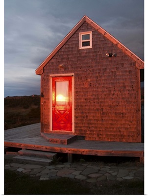 Canada, Nova Scotia, Cape Breton, Cabot Trail Cottage at sunset