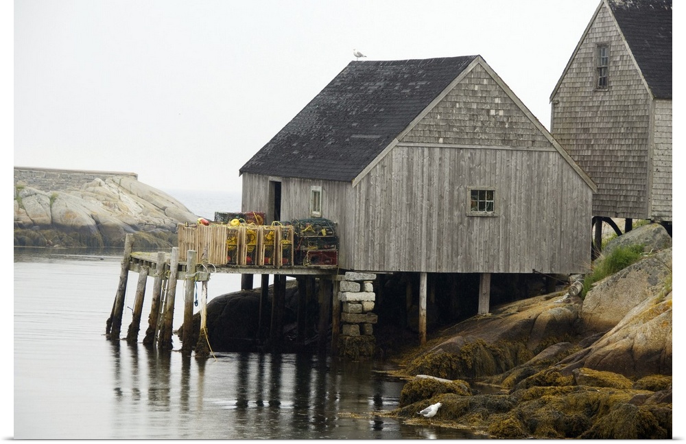 Canada, Nova Scotia, Peggy's Cove. Lobster traps on typical wooden dock.