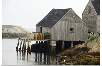 Canada, Nova Scotia, Peggy's Cove. Lobster traps on typical wooden dock