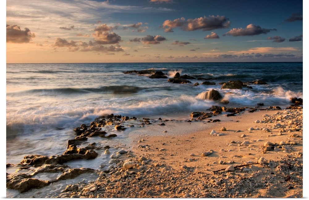 Caribbean Sea, Cayman Islands.  Crashing waves at sunset on the shore near George Town.