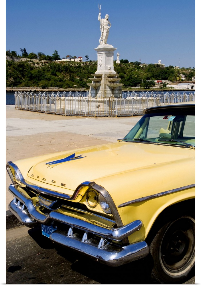 Classic Dodge 50s auto in front of river and statues with Christ statue on hill in background in Havana Cuba Habana