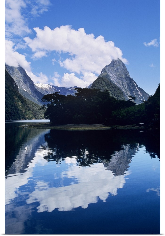 Cloud-capped Mitre Peak rises out of Milford Sound in Fiordland National Park, South Island, New Zealand.