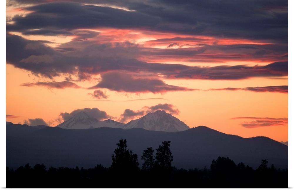 USA, Oregon, Bend. Clouds gather around the Soth and Middle Sisters at sunset in Deschutes County, Oregon.