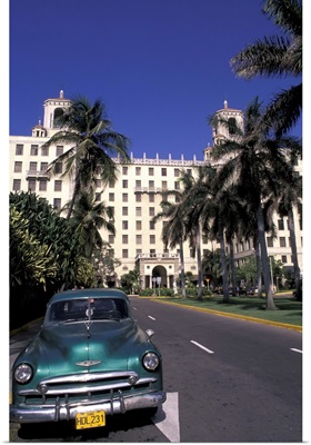 Cuba, Havana. Classic 1950's auto in front of Habana Nacional Hotel