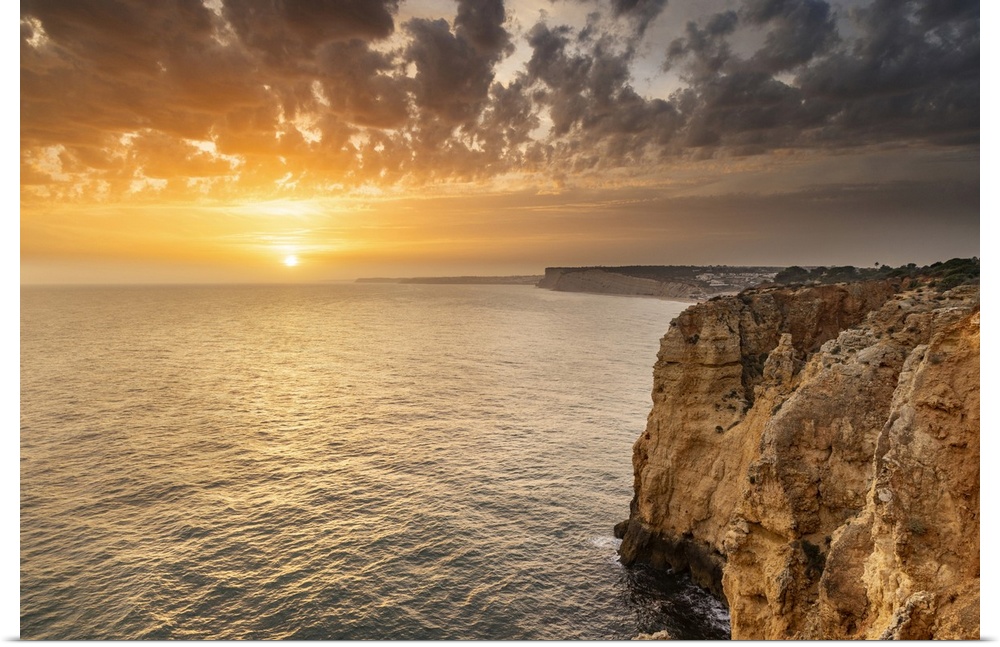 Dramatic sunset clouds over Cliffs along the coast at Ponta da Piedade in Lagos, Portugal.