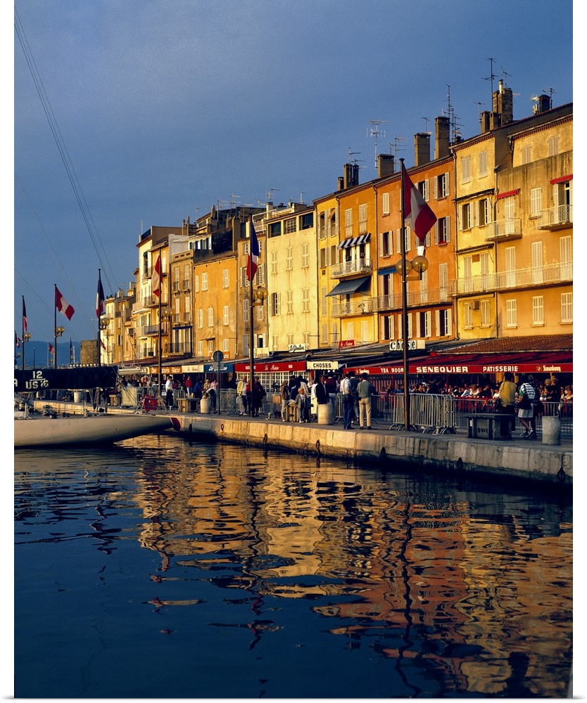 Europe, France, St. Tropez. The cafes along the harbor are filled with people-watchers in St. Tropez on the Riviera in Fra...