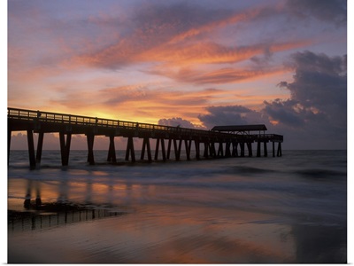Georgia Tybee Island, pier at sunrise with reflections of clouds on beach