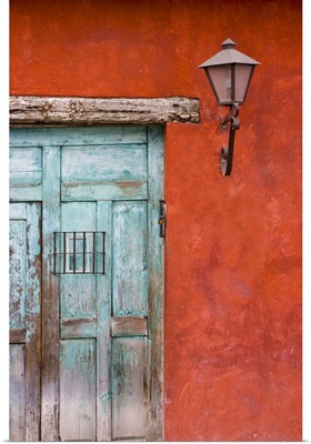 Guatemala, Antigua, aqua blue door against colorful red wall in Antigua