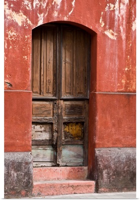 Guatemala, Antigua, exterior wall and wooden door along the streets of Antigua