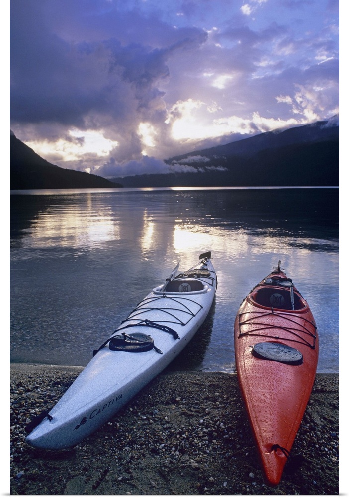 Kayaks at sunset on Rainbow Falls Beach on Azure Lake in Wells Gray Provincial Park, British Columbia, Canada.