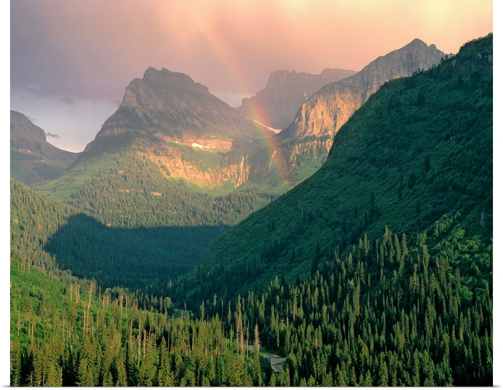 USA, Montana, Glacier NP. A rainbow graces the mountains seen from Going-to-the-Sun Highway, Glacier NP, Montana