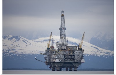 Offshore oil drilling rig in Cook Inlet and distant Alaska Range peaks
