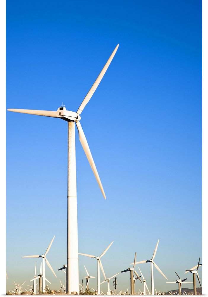 Palm Springs, California. View of wind turbines in the desert under a clear blue sky.