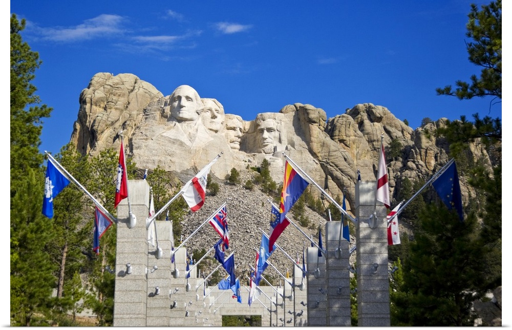 USA, South Dakota, overview of Mount Rushmore National Memorial in daytime, framed by Grand View Terrace with flags in for...