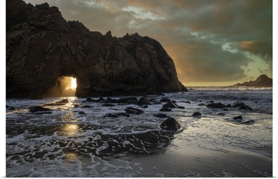 Sunset Shines Through A Tunnel In This Sea Rock At Big Sur