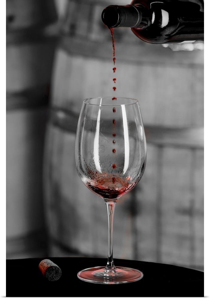 USA, Washington state, Woodinville. Red wine pouring into is captured in mid-air before it touches wine glass.