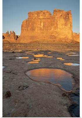 Utah, Arches National Park. Reflected light from the Organ in icy pot holes