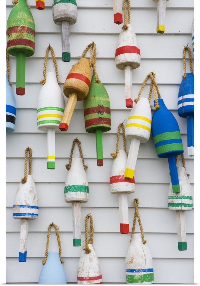 Wooden lobster buoys hang on a wall in Stonington, Maine.