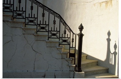 Wrought iron railing and steps with shadow detail