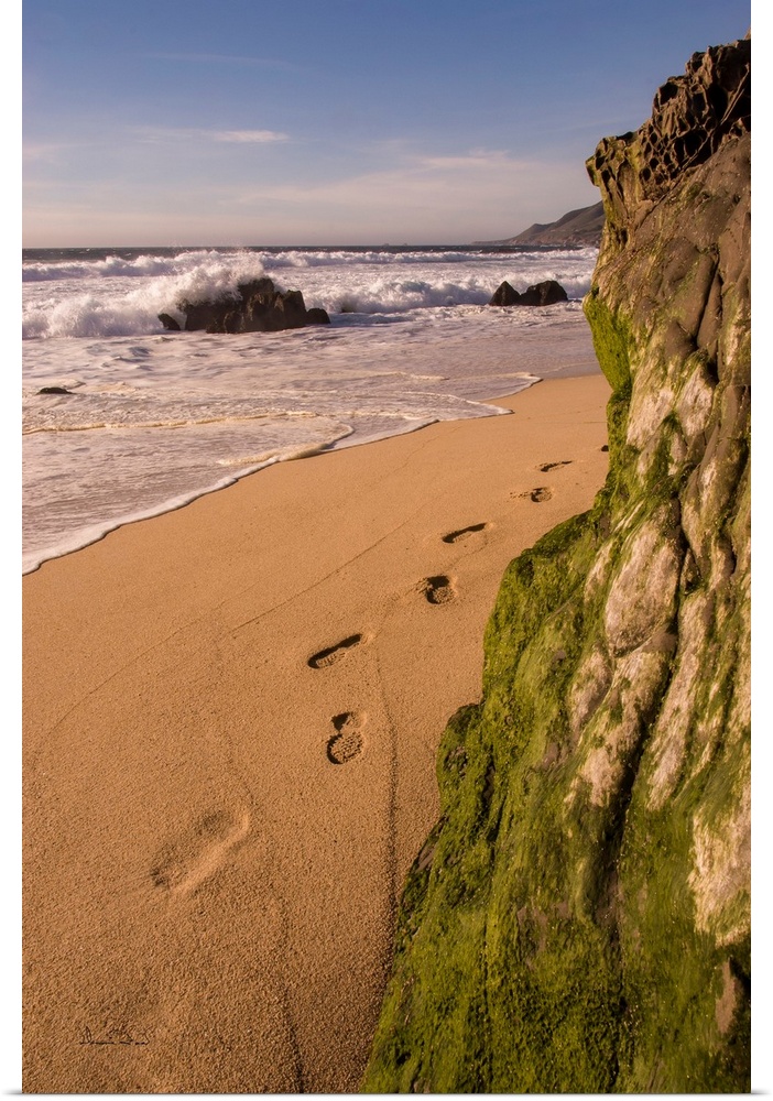 Footprints and sand beach along the California Coast, Garapata Beach, California, USA.