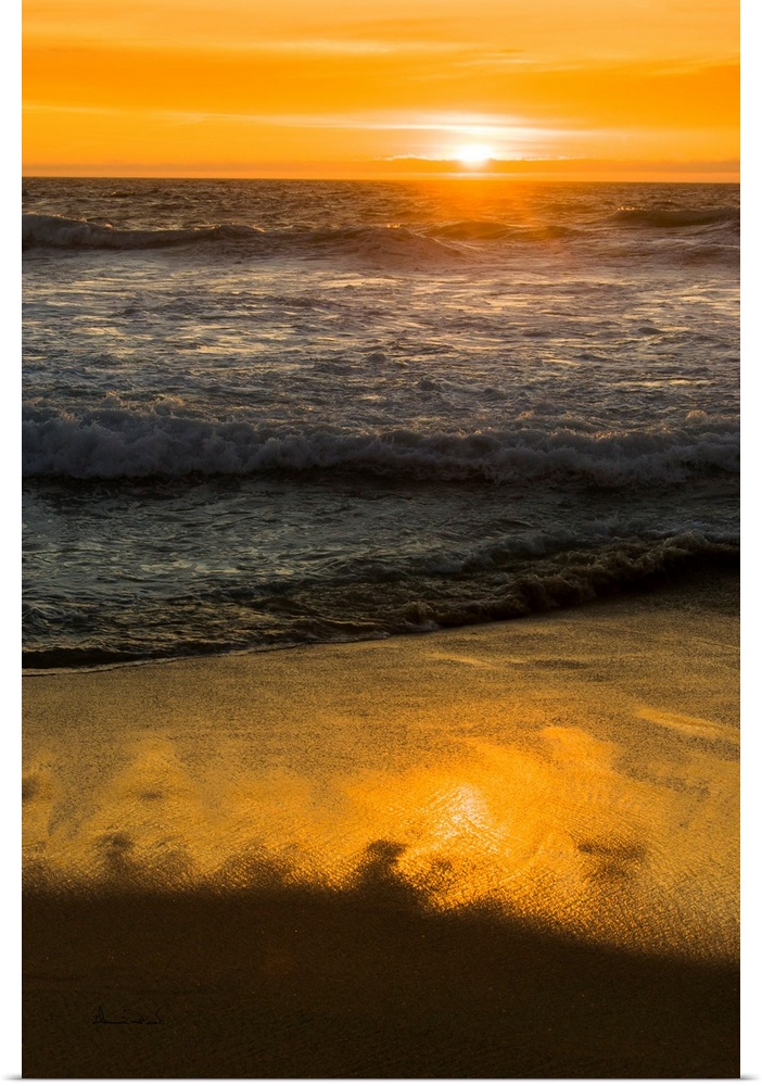 Rocks and Ocean Waves at sunset along the California Coast near Carmel, California, USA.