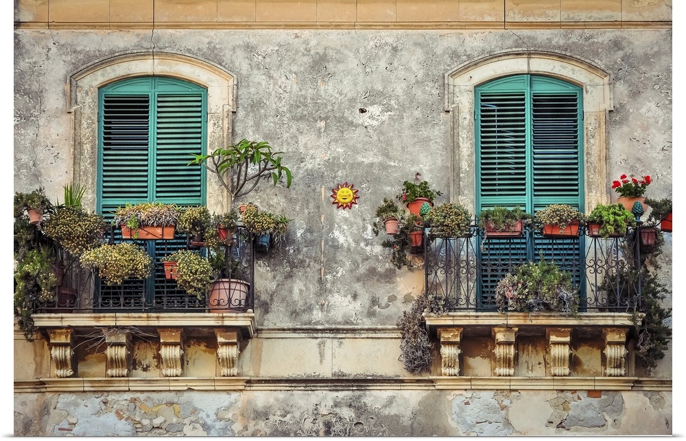 Beautiful vintage balcony with colorful flowers and wooden doors, Mediterranean style.