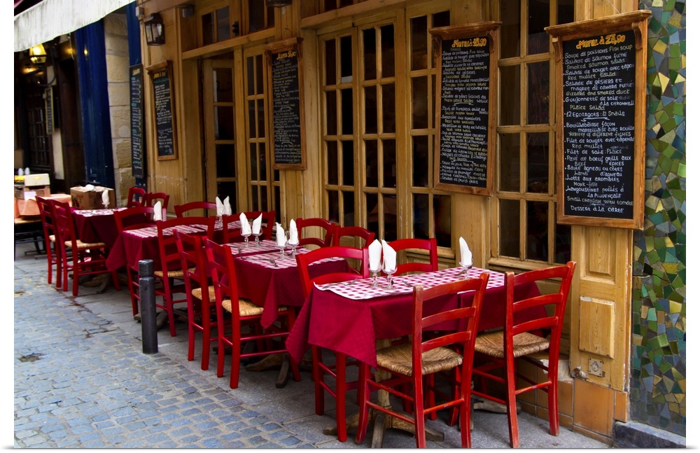 French restaurant with tables and chairs on the street in Paris, France.