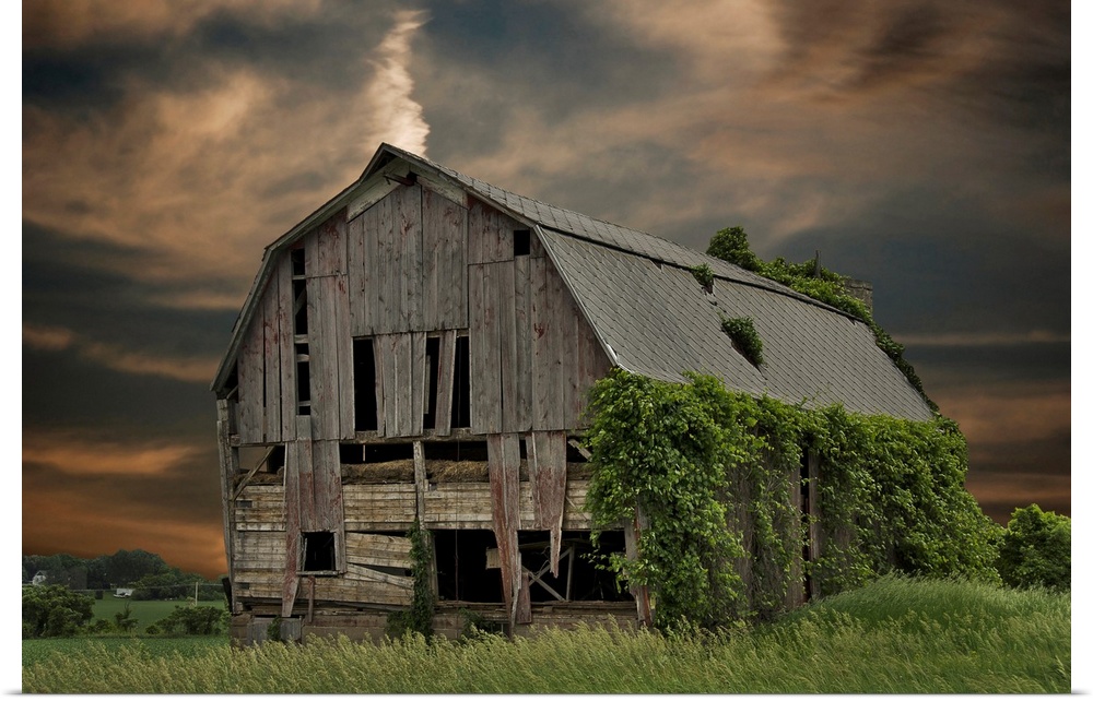 Dilapidated old barn with sunset sky.