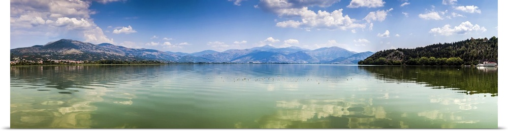 Panoramic view of Kastoria lake under blue sky, Greece.