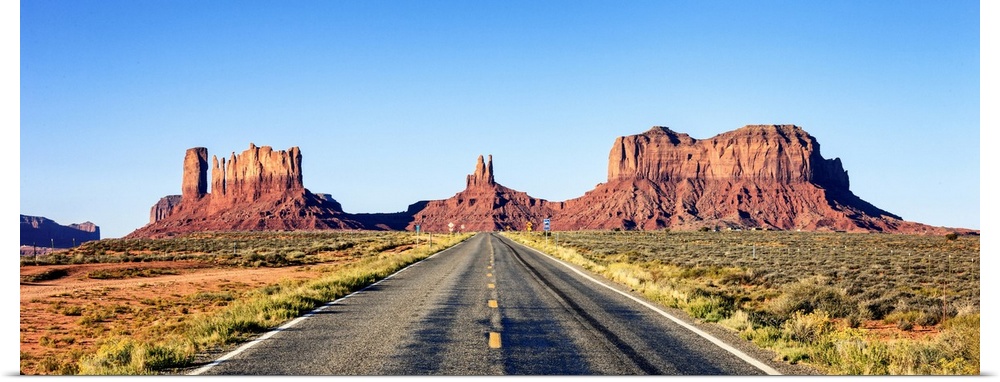 Panoramic view of long road at monument valley, USA.