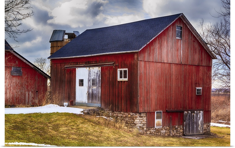 Large red bank barn. New roof. Crisp colors and overcast sky.