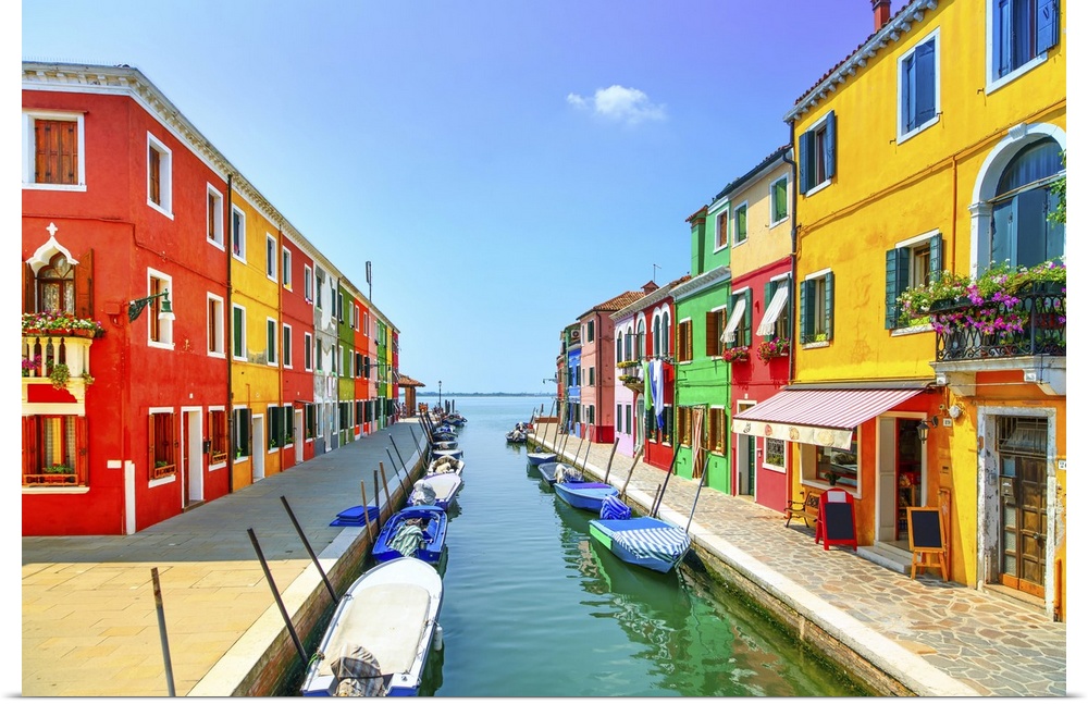 Venice landmark, Burano island canal, colorful houses and boats, Italy. Long exposure photography.