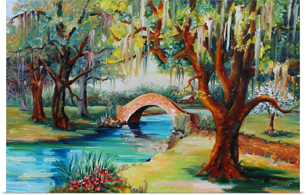 A park with a small stone bridge over a stream and a live oak tree.
