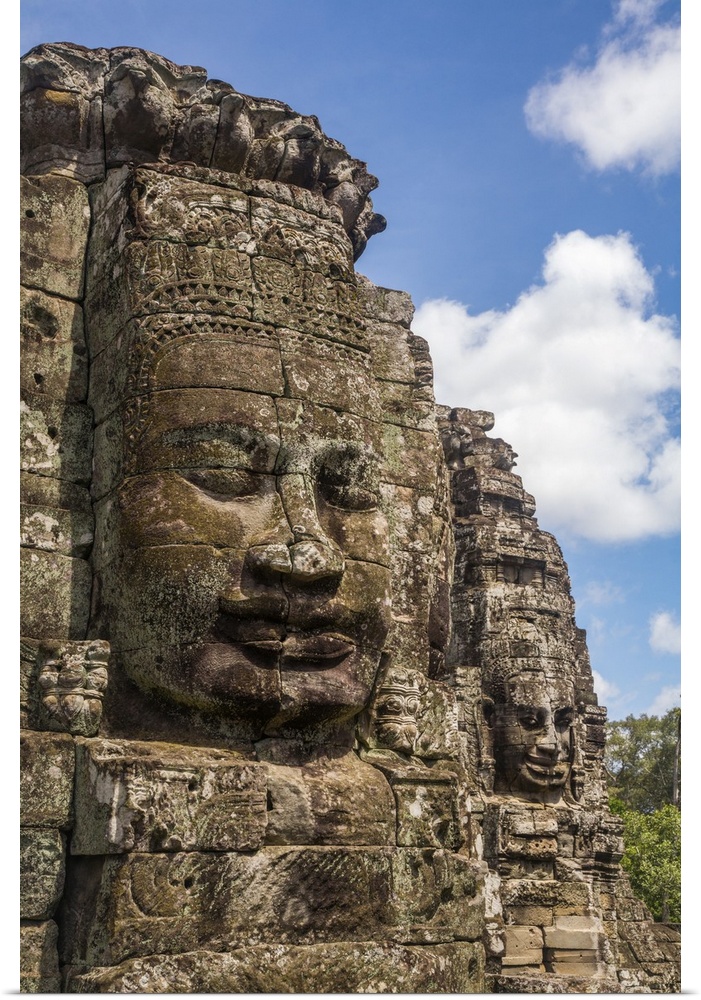 Cambodia, Siem Reap, Angkor, Giant stone faces at the Bayon temple mountain at the UNESCO World Heritage site of Angkor Ar...