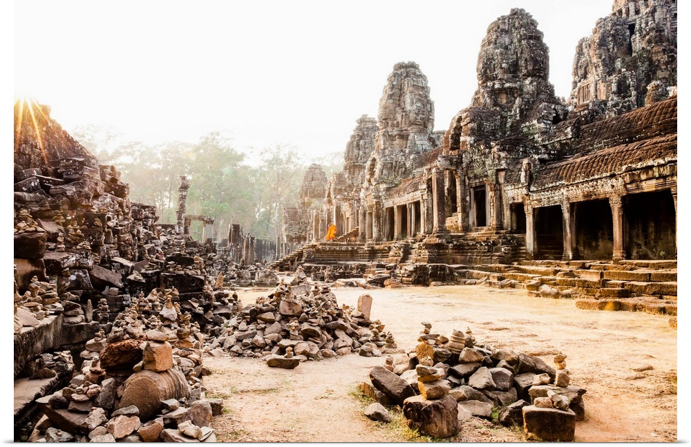 Cambodia, Siemreab, Angkor, Monks leaving the Bayon Temple at sunset.