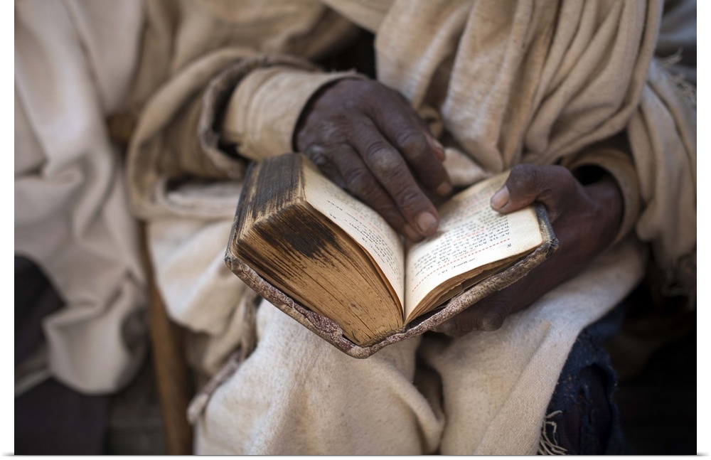 Ethiopia, Amhara, Lalibela, Priest reading an old Bible, Bete Maryam (House of Mary).