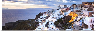 Greece, Aegean islands, Cyclades, Santorini island, Oia village illuminated at dusk