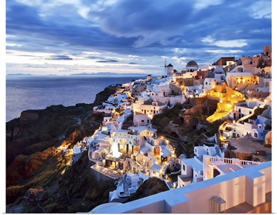 Greece, Aegean islands, Cyclades, Santorini island, Oia village illuminated at dusk
