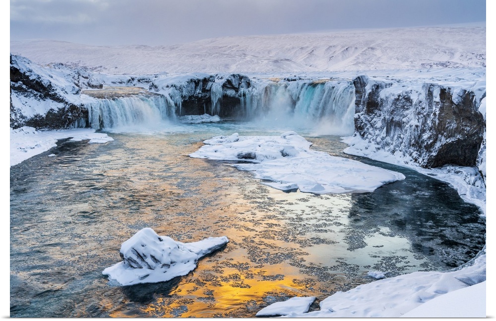 Iceland, Northeast Iceland, Sunset over a snow-covered Godafoss.