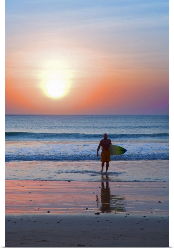 Indonesia, Bali Island, Jimbaran, Surfer on the beach at sunset