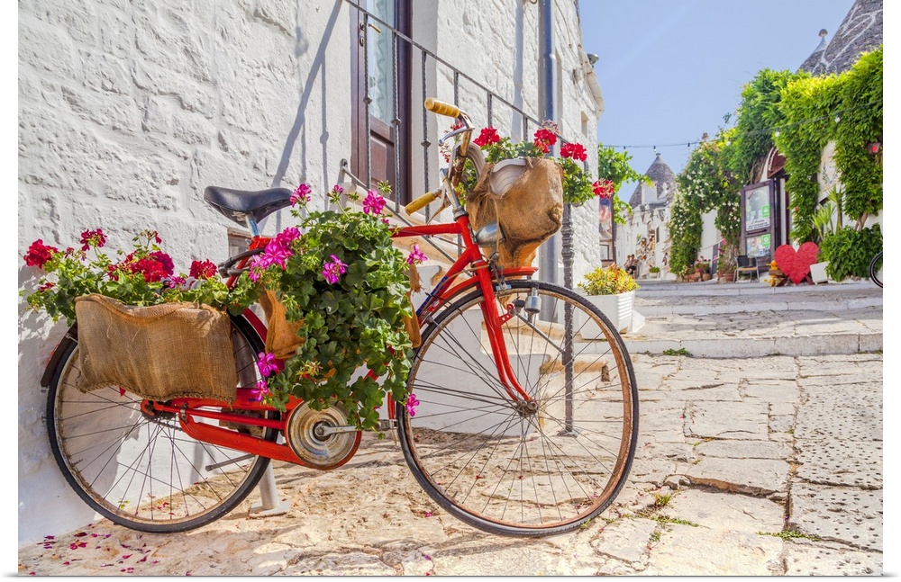 Italy, Apulia, Bari district, Itria Valley, Alberobello, Bicycle in a typical street of Alberobello.