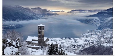 Italy, Lombardy, Como Lake, Peglio, Sant'Eusebio church and the lake with snow