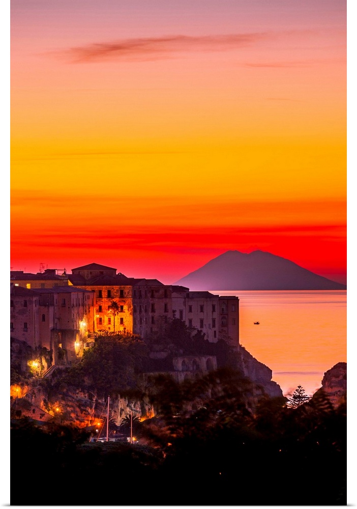Italy, Calabria, Mediterranean area, Vibo Valentia district, Tropea, Town at sunset with Stromboli Island in the background.
