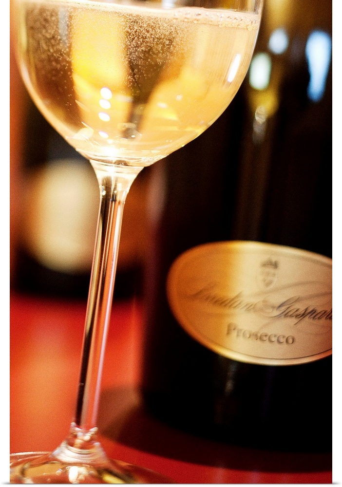 Italy, Veneto, Conte Loredan Gasparini cellar, glass and bottles of Prosecco wine