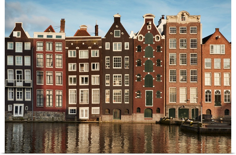 Netherlands, North Holland, Amsterdam, Typical Dutch houses along the Damrak Canal.